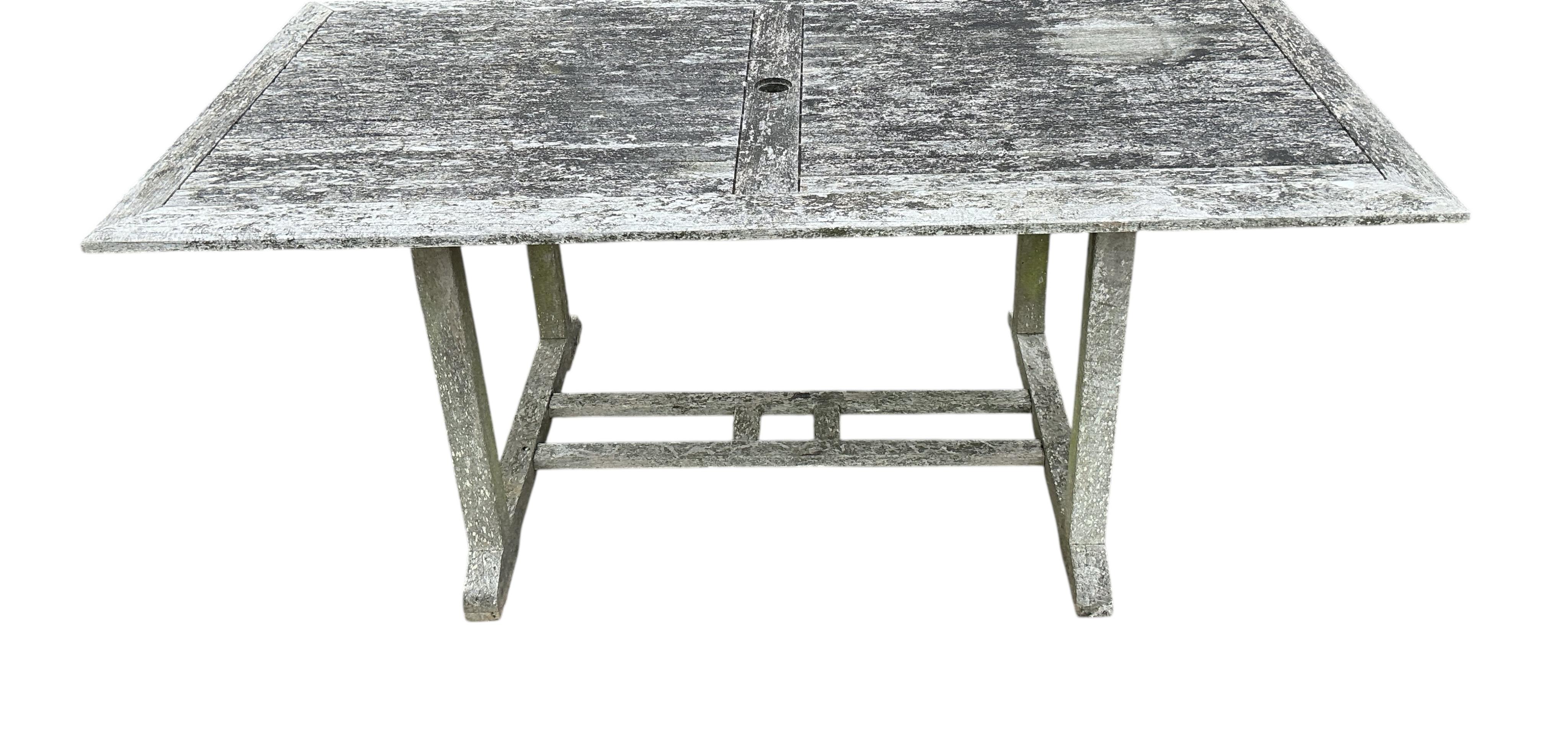 A rectangular weathered teak garden table, width 178cm, depth 90cm, height 72cm together with six Lindsey teak folding garden chairs